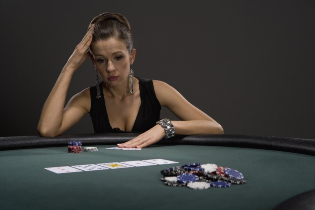 A woman contemplating her hand in poker