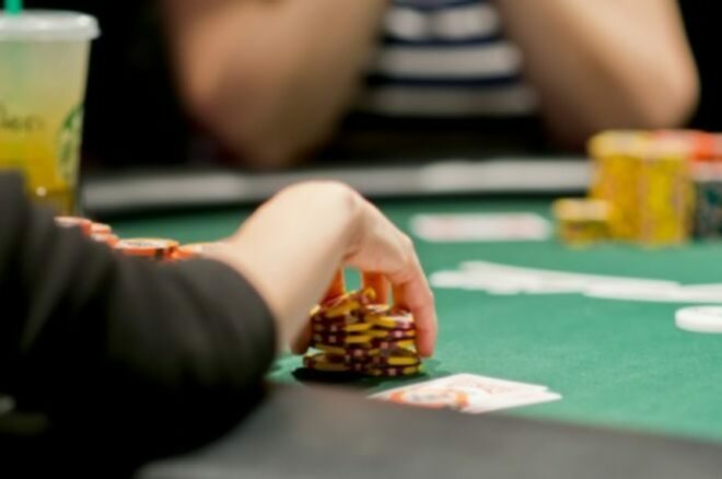 A poker player handling his chips during a game