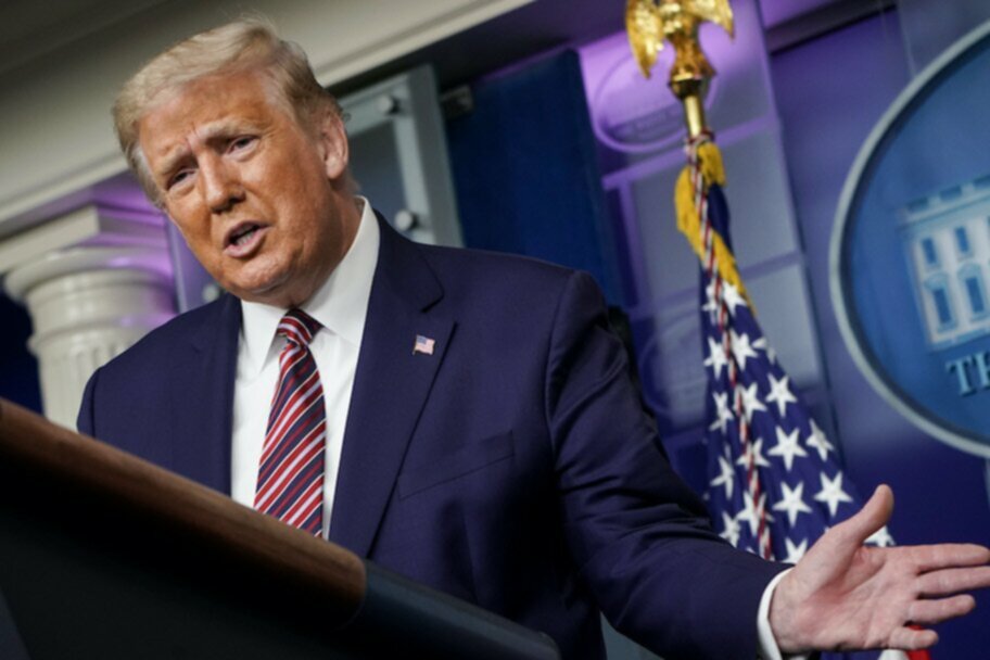 donald trump giving speech in front of american flag at white house