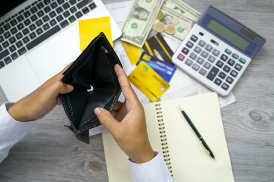 empty wallet with money and credit cards on table