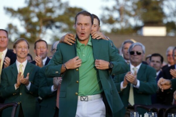 Jordan Spieth puts the Green Jacket on Danny Willett