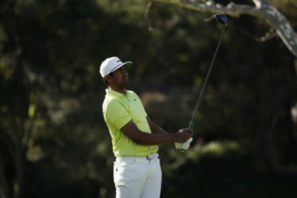 Tony Finau watches his golf shot