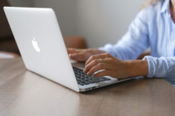 person at laptop computer placing online sports bet