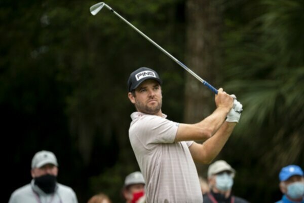 Corey Conners watches his golf shot