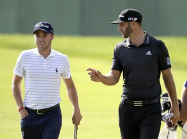 Justin Thomas and Dustin Johnson talk on the golf course