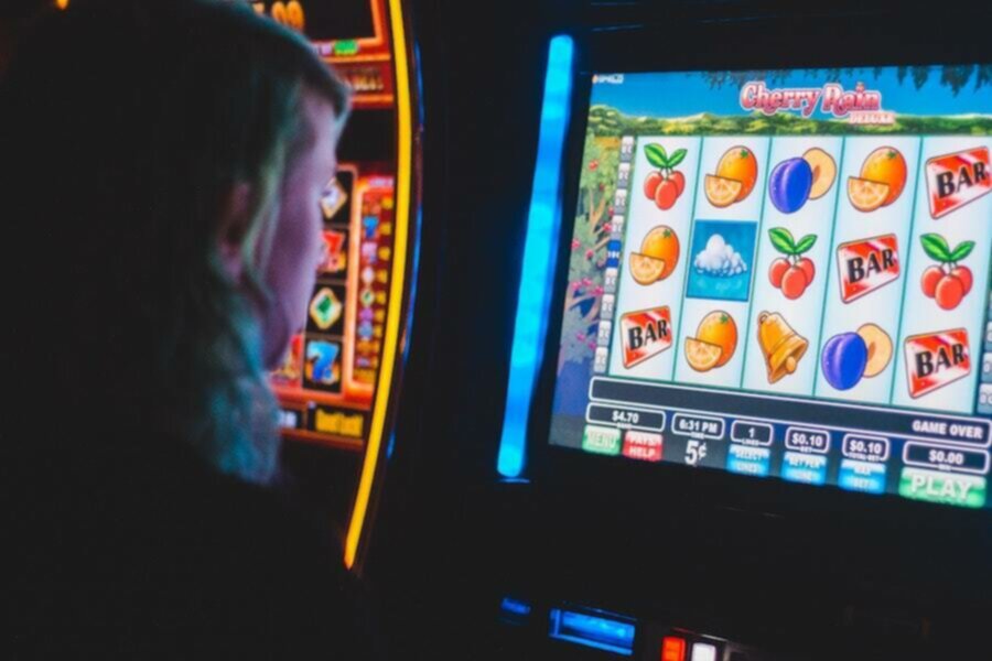 women sitting in front of slot machine