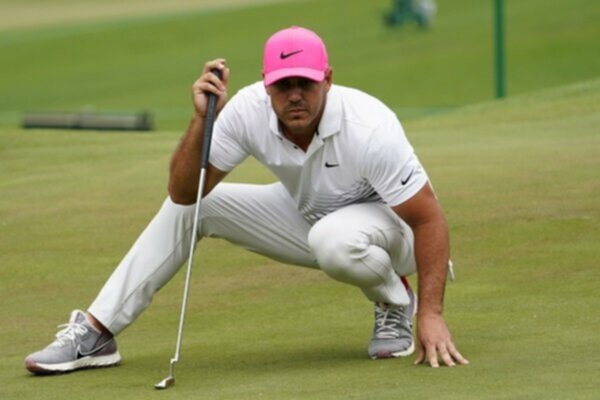 Brooks Koepka reads a putt