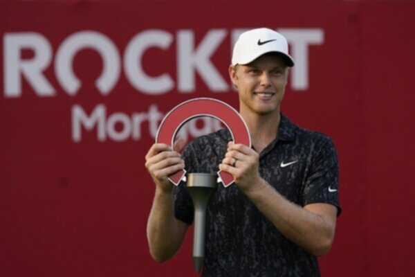 Cam Davis poses with the Rocket Mortgage Classic trophy