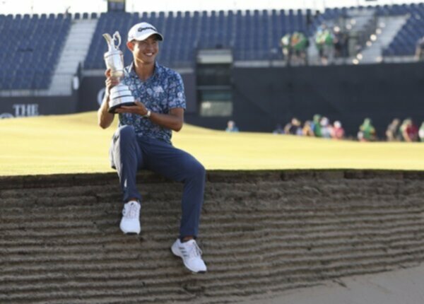 Collin Morikawa poses with the Claret Jug