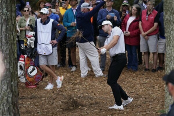 Sam Burns hits out of the pine straw at TPC Sawgrass