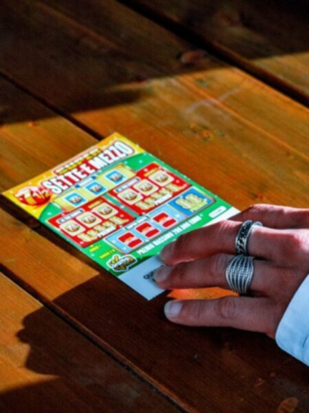 woman playing scratch off lottery card