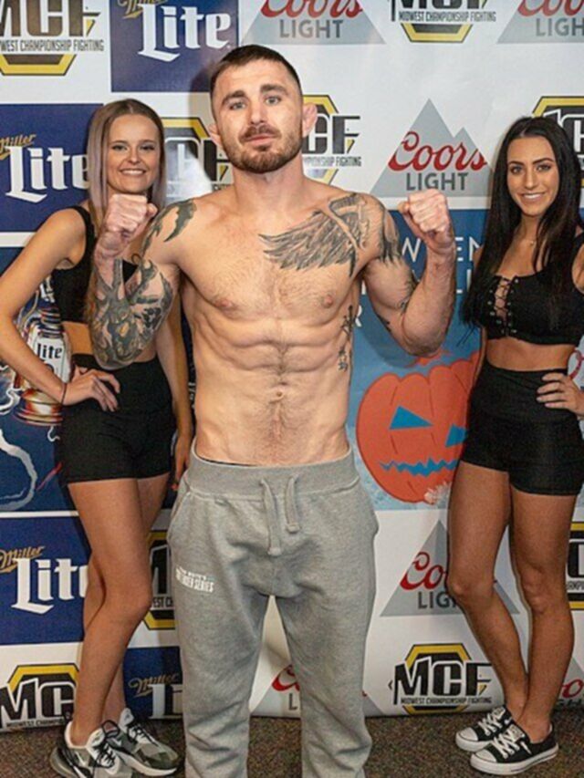 darrick minner standing by two woman flexing arms